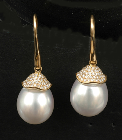 Appraisal: A pair of South Sea pearl earrings The oval shaped