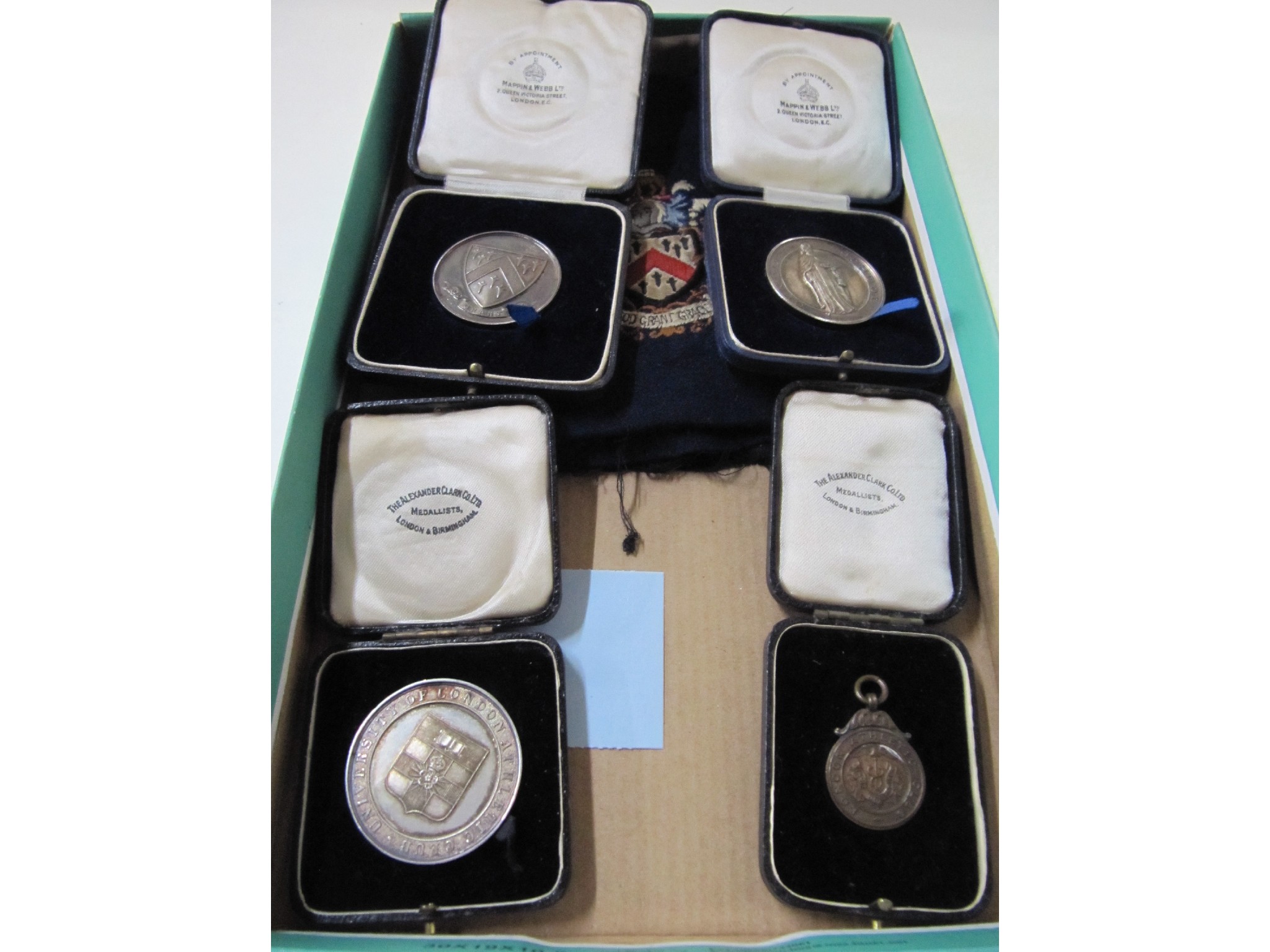 Appraisal: A lot comprising three school shot putting medallions a London