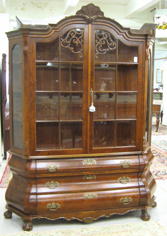 Appraisal: MAHOGANY AND BURL WALNUT CHINA CABINET ON BOMBE CHEST Dutch