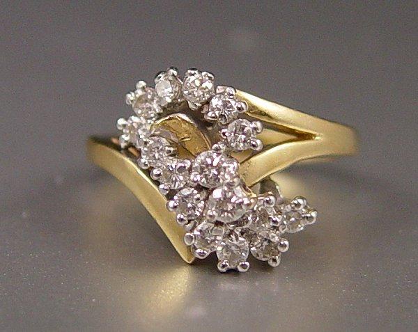 Appraisal: K DIAMOND FASHION RING K yellow gold ring contains sixteen