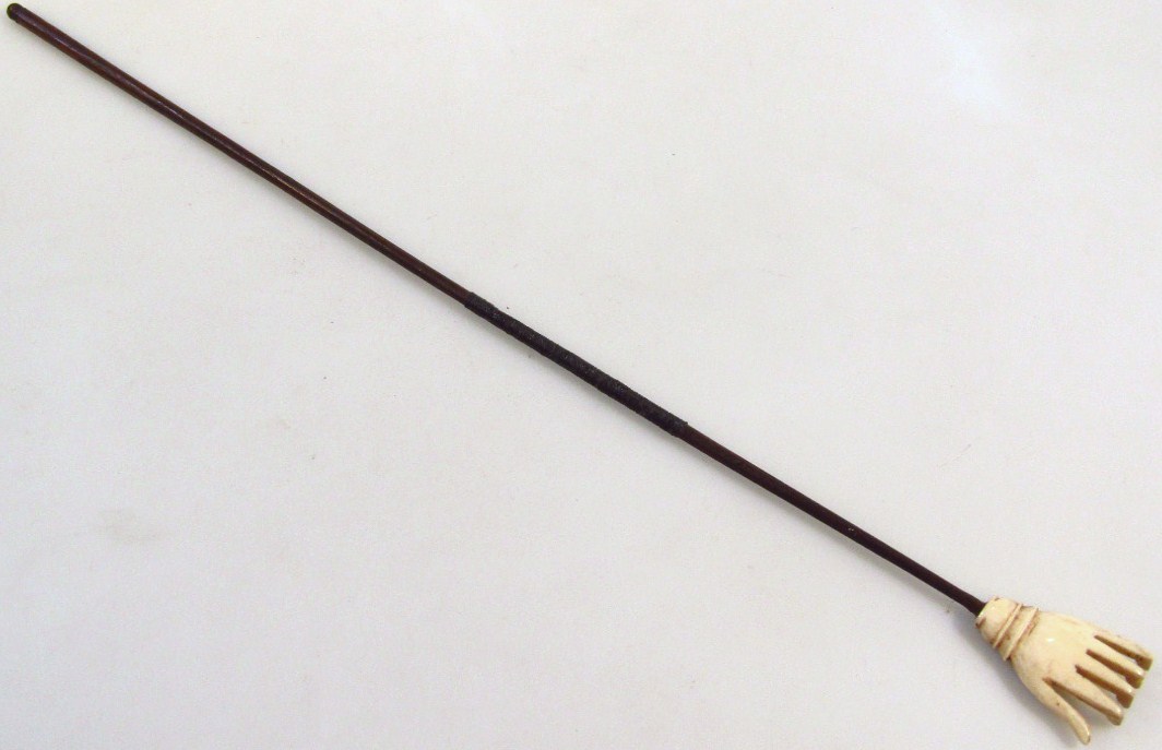 Appraisal: A late thC back scratcher with slender part turned stem