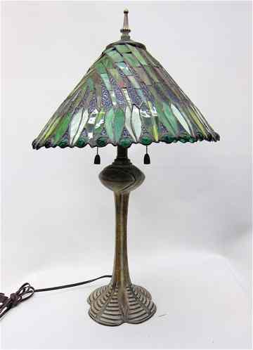 Appraisal: A STAINED AND LEADED GLASS SHADED TABLE LAMP The patinated