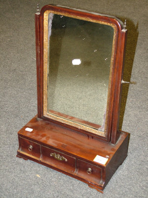 Appraisal: A Georgian mahogany toilet mirror the rectangular plate flanked by