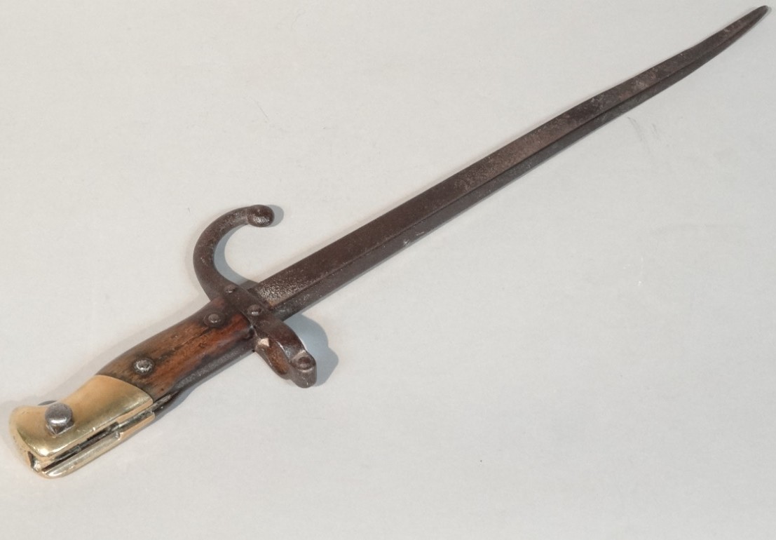 Appraisal: A late thC bayonet with shortened shaped blade with brass