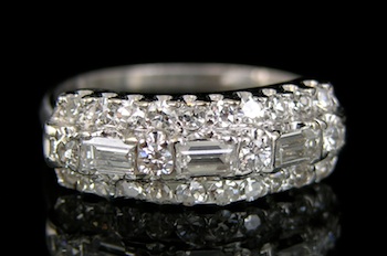 Appraisal: A Platinum and Diamond Band Platinum band set across the