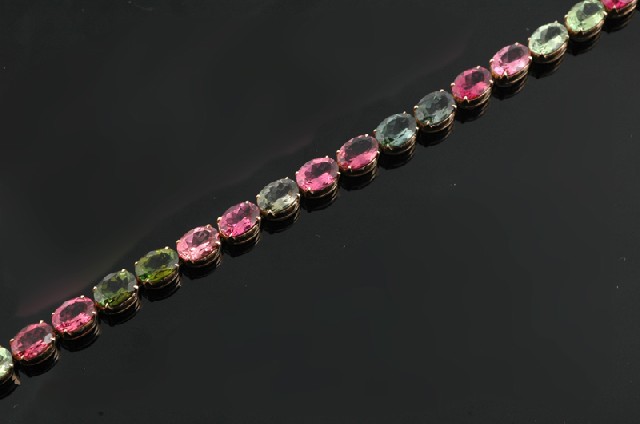 Appraisal: A multi coloured tourmaline bracelet Comprising twenty five oval cut