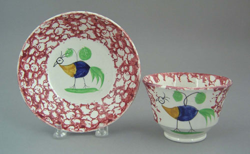 Appraisal: Red spongeware cup and saucer th c with baby peafowl