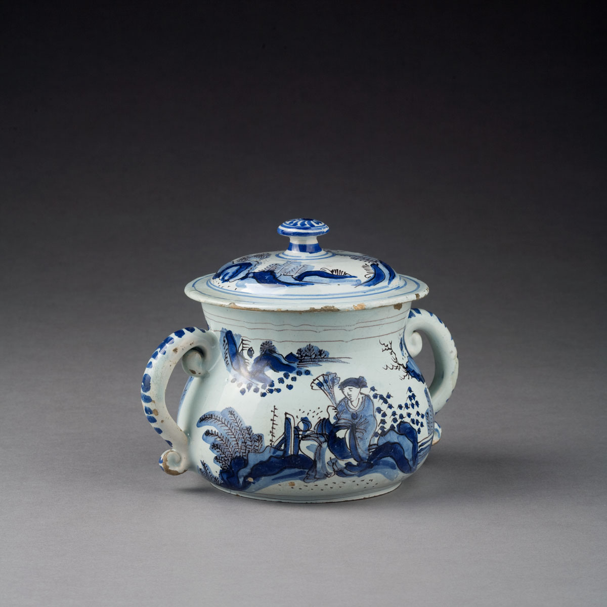 Appraisal: ENGLISH DELFT BLUE AND WHITE CHINOISERIE TWO-HANDLED CUP AND COVER