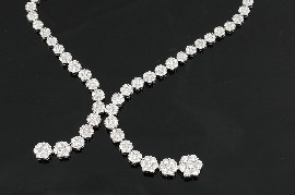 Appraisal: A diamond flower cluster necklace Comprising ninety nine graduated diamond