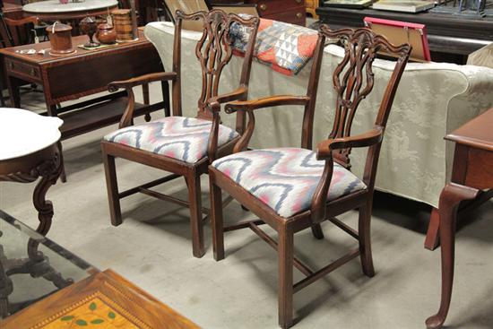 Appraisal: PAIR OF CHIPPENDALE STYLE ARMCHAIRS Walnut chairs with flame upholstery