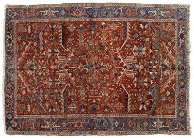 Appraisal: Heriz rug repeating geometric and floral designs on varying red