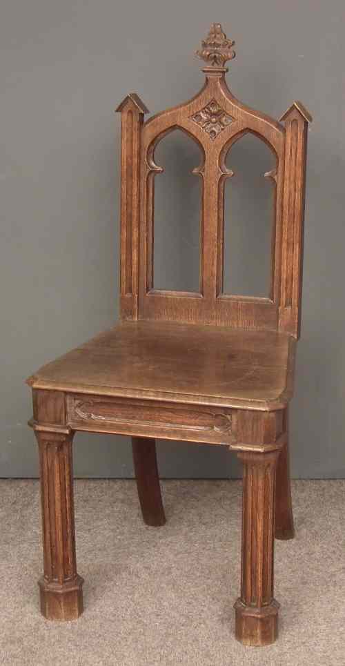 Appraisal: A Victorian oak hall chair of ''Gothic'' design with carved