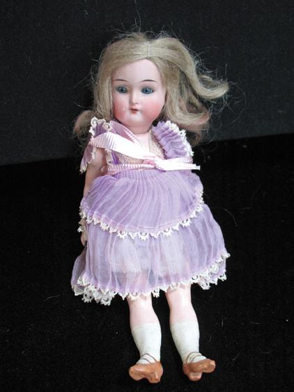 Appraisal: A KAMMER AND REINHARDT MINIATURE PORCELAIN DOLL with a bisque