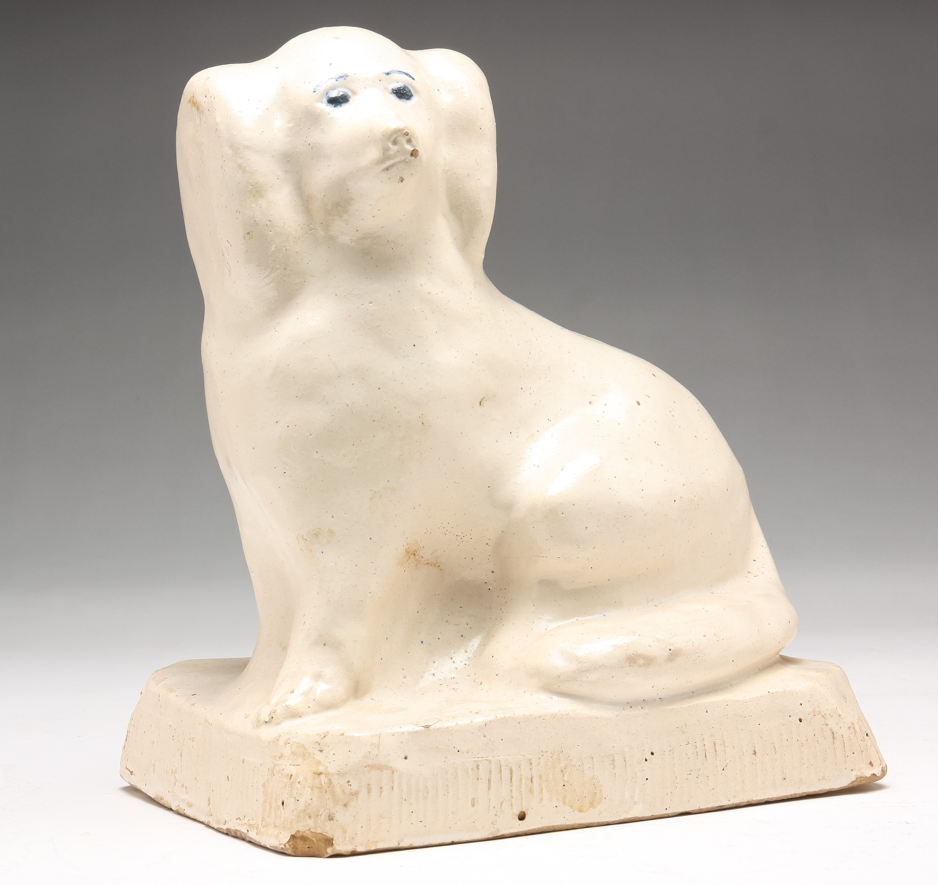 Appraisal: AMERICAN POTTERY DOG Probably Ohio mid th century Seated spaniel