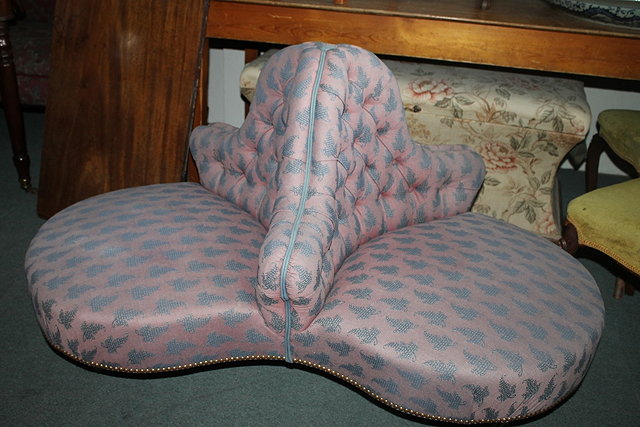 Appraisal: A VICTORIAN MAHOGANY UPHOLSTERED CONVERSATION SEAT upholstered in pink and