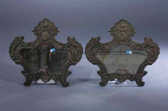 Appraisal: PAIR CONTINENTAL BRASS REPOUSSE CARTOUCHE-SHAPE WALL MIRRORS late th-early th