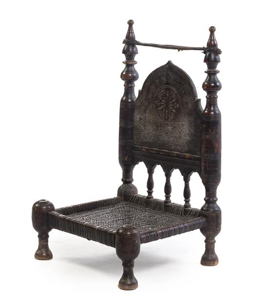 Appraisal: Sale Lot An African Carved Hardwood Chair having an arched