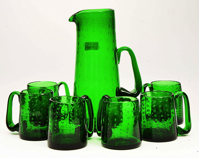 Appraisal: AN EMERALD GREEN GLASS ALE SET possibly Whitefriars with bubble