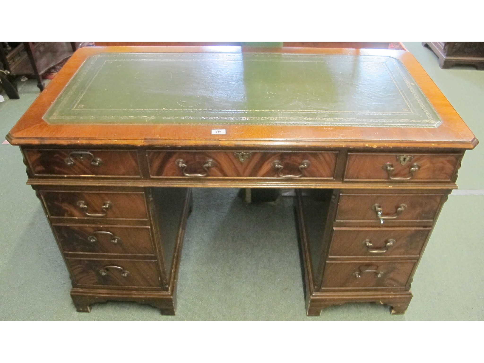 Appraisal: A mahogany pedestal desk with green leather insert