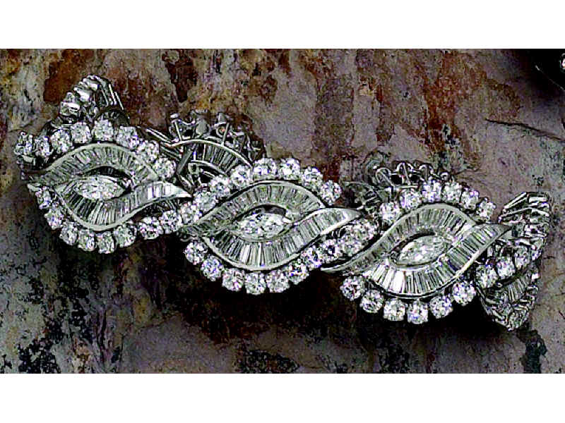 Appraisal: DIAMOND BRACELET Flexible platinum bracelet formed of seven stylized scroll