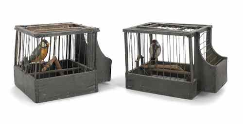 Appraisal: Two carved and painted birds in wood and wire cages