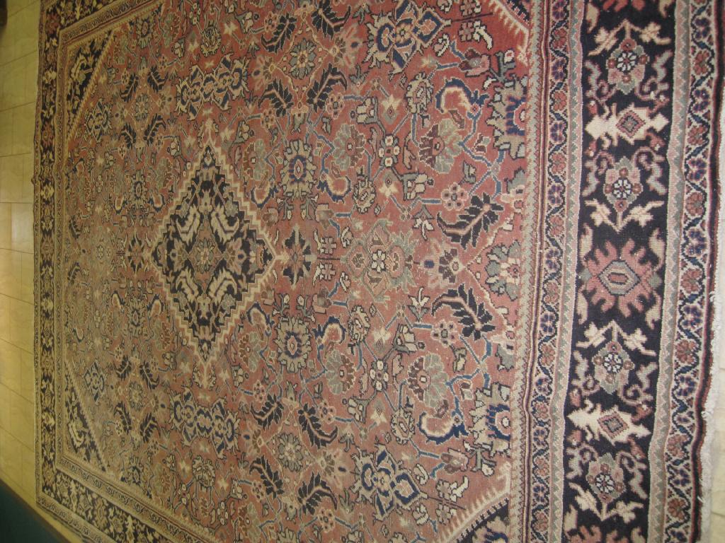 Appraisal: A large Ferahagn bordered Carpet with floral and palmette design