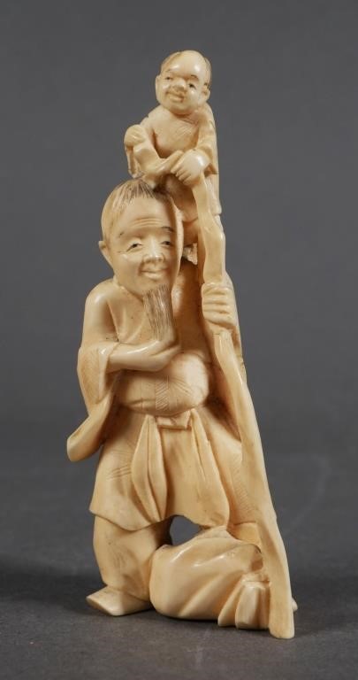 Appraisal: Old ivory carving of man and child - high Please