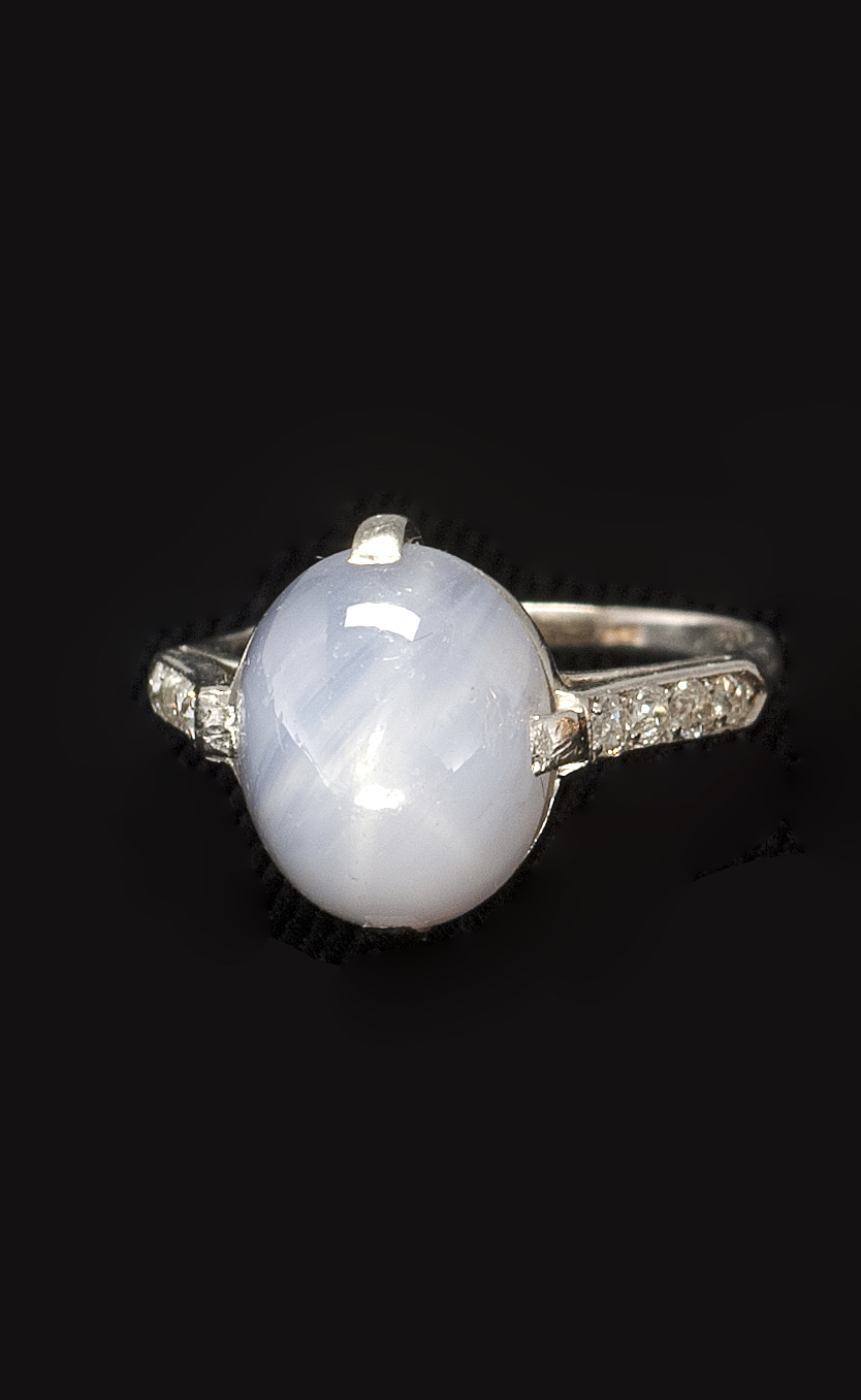 Appraisal: PLATINUM DIAMOND AND STAR SAPPHIRE RING Cabochon sapphire flanked by