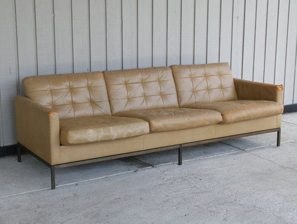 Appraisal: Florence Knoll leather upholstered three cushion sofa on bronze frame