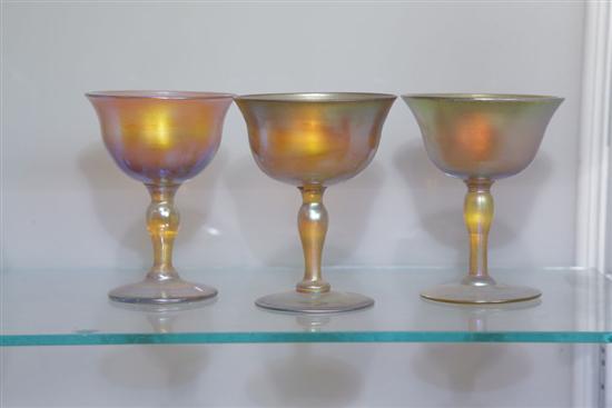 Appraisal: THREE ART GLASS SHERBERTS Similar footed sherberts in iridescent gold