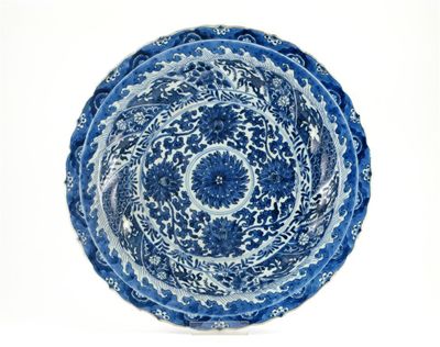 Appraisal: A Chinese blue and white moulded charger with a foliate