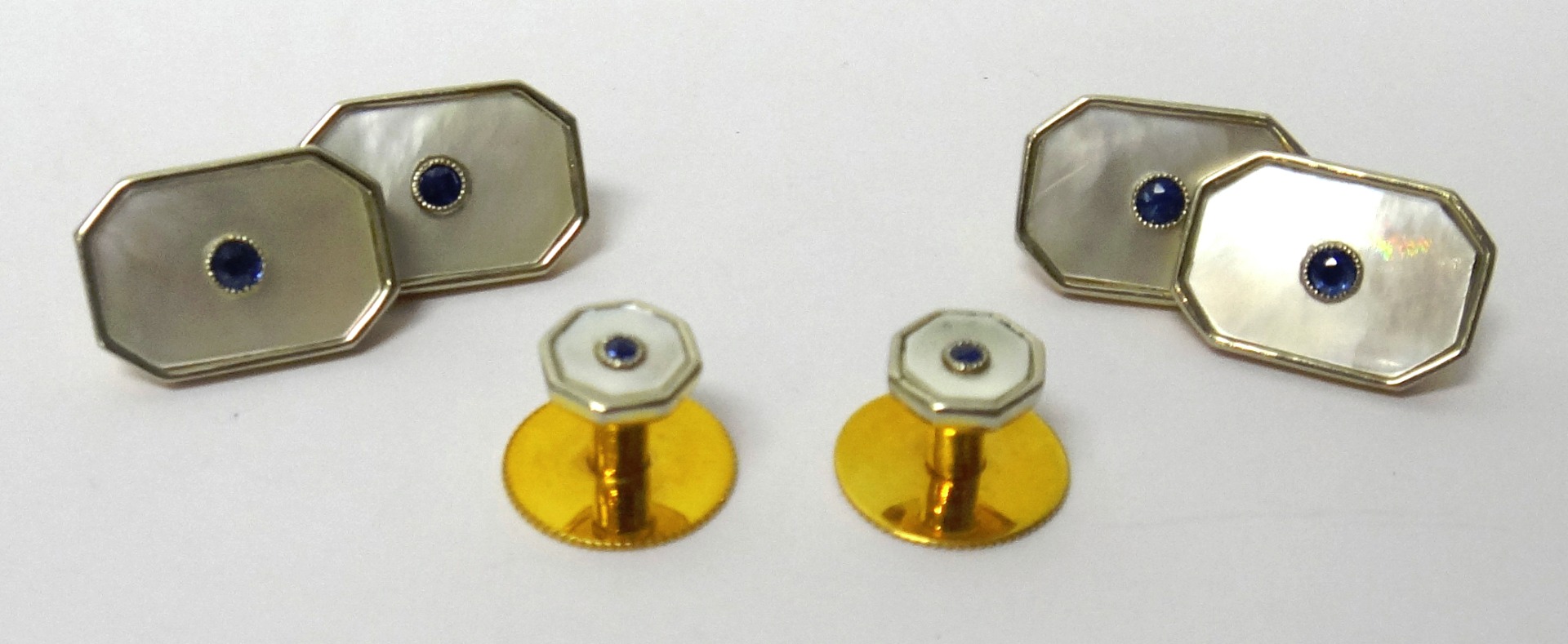 Appraisal: A pair of gold sapphire and mother of pearl set