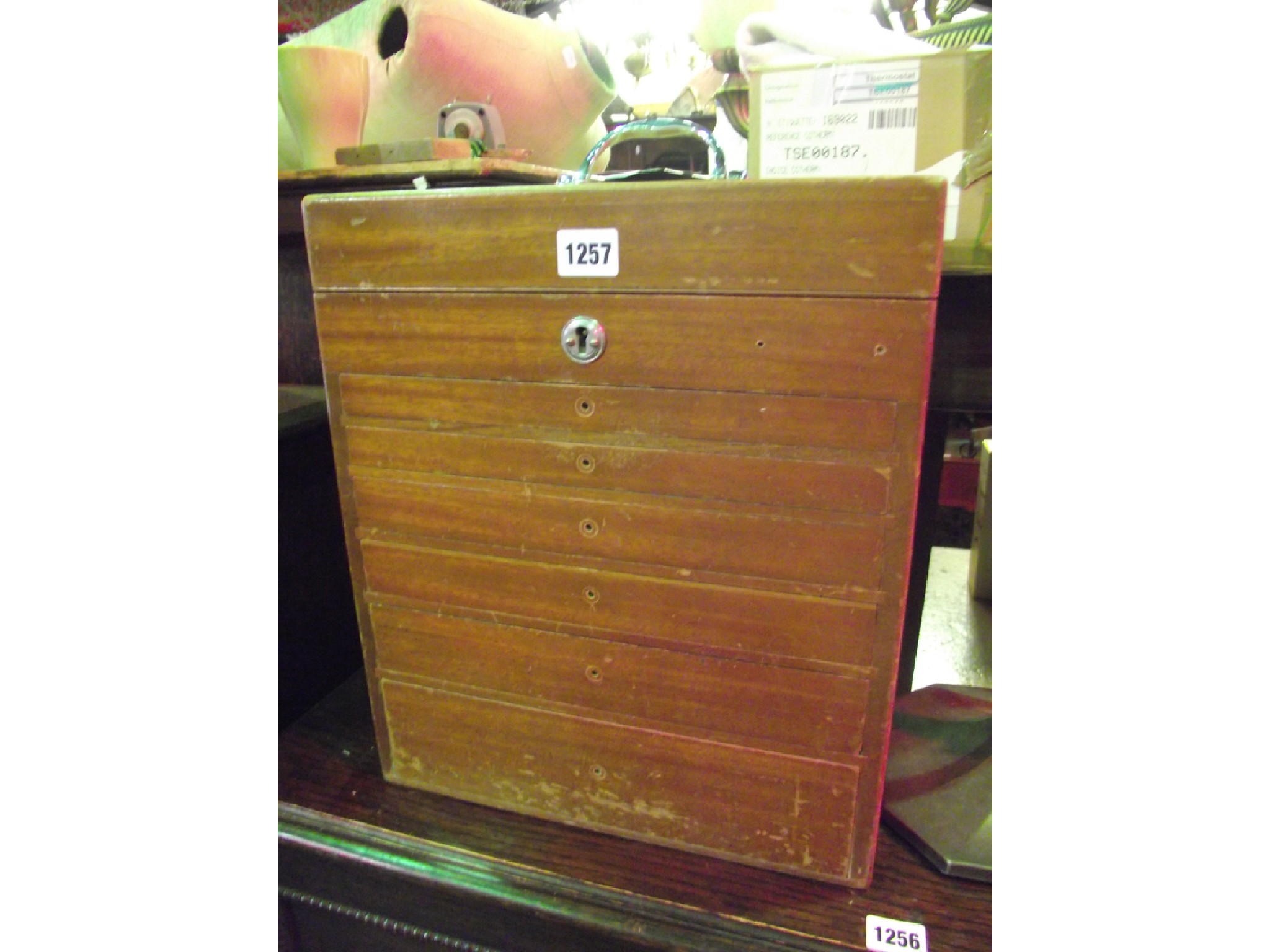 Appraisal: A portable vintage teak cabinet with hinged lid over six