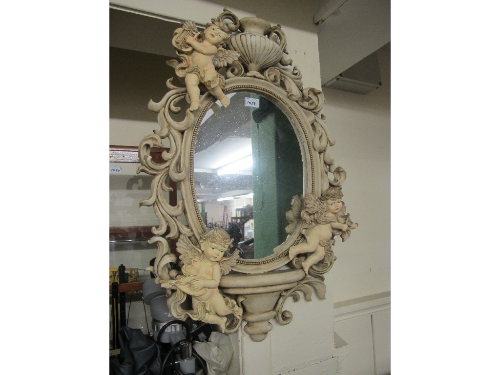 Appraisal: Composition cherub decorated wall mirror