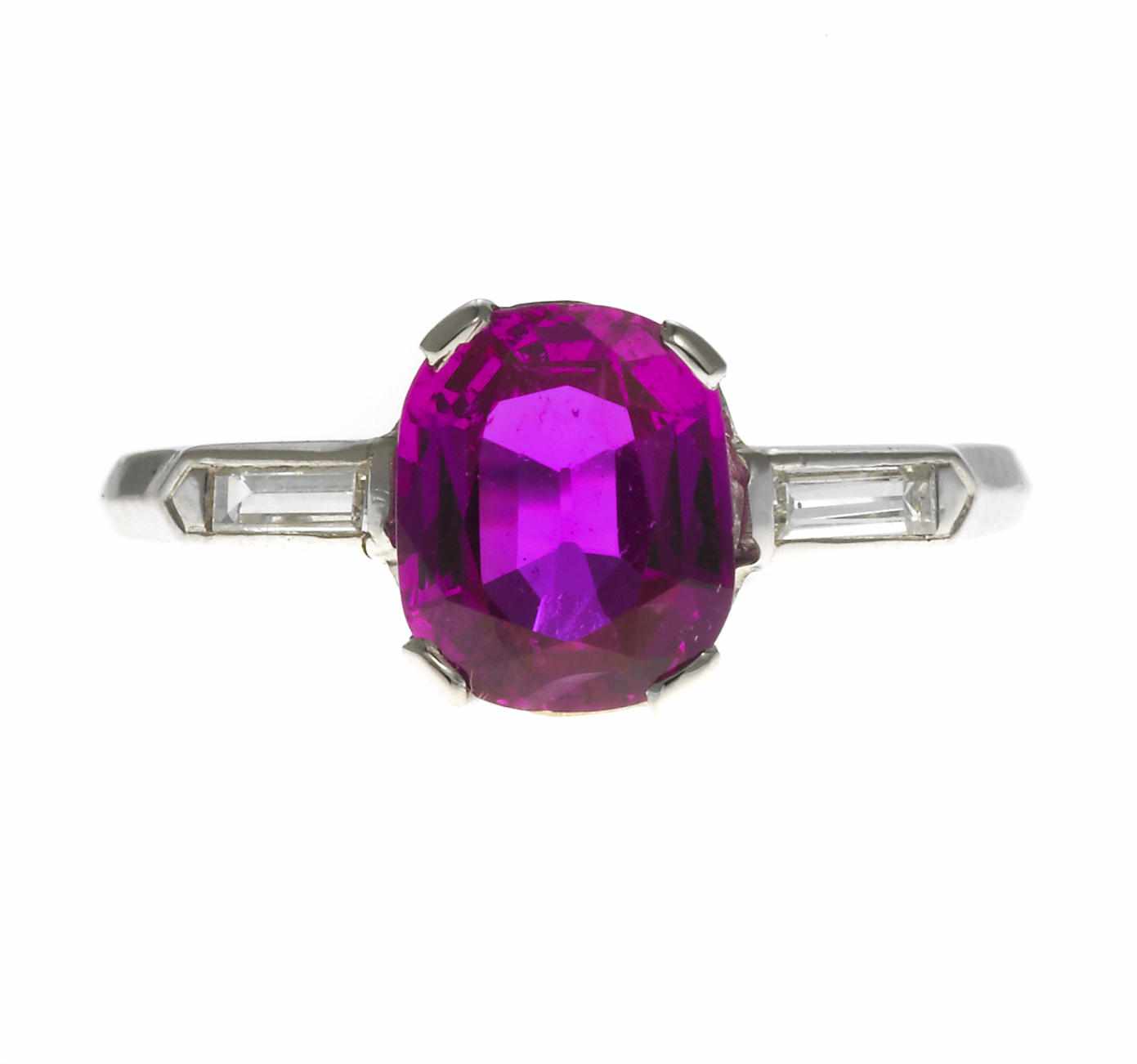 Appraisal: A ruby and diamond ring centering a cushion-cut ruby weighing