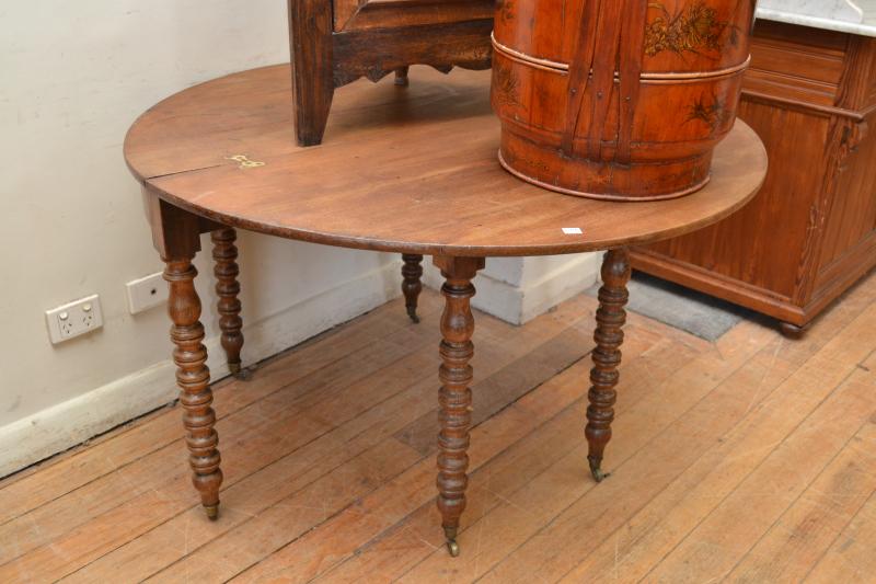 Appraisal: A FRENCH OAK CIRCULAR FLIP TOP TABLE ON TURNED LEGS