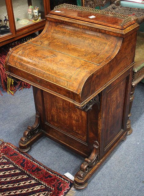 Appraisal: A VICTORIAN PIANO TOP WALNUT DAVENPORT DESK with spring loaded