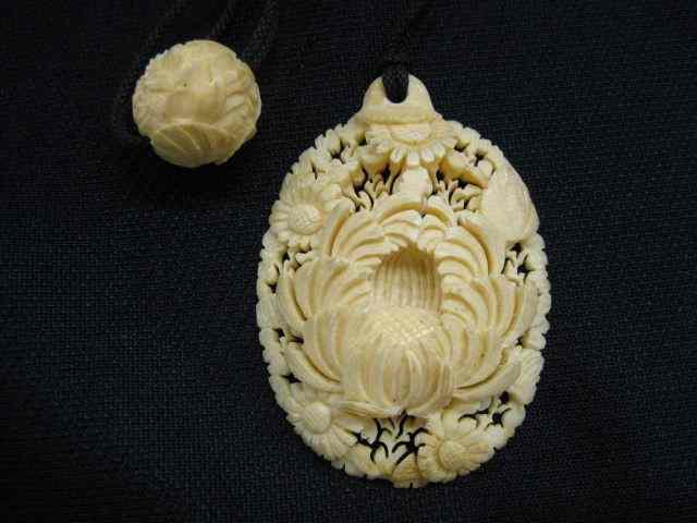 Appraisal: Carved Ivory Pendant deep chrysanthemum other flowers oval '' x