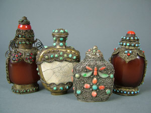 Appraisal: Four Sino-Tibetan hardstone and gilt metal snuff bottles inlaid with