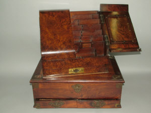 Appraisal: A Victorian burr walnut slope front stationery writing cabinet with