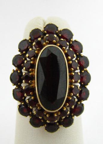 Appraisal: Lady's K yellow gold garnet ring bezel and prong set