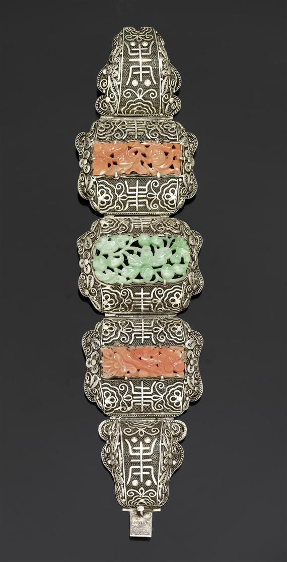 Appraisal: A VERY DECORATIVE SILVER BRACELET WITH JADEITE AND CORAL CARVINGS