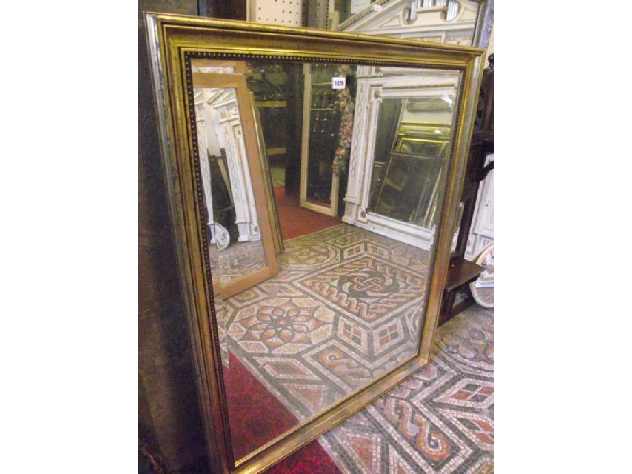 Appraisal: A gilt framed wall mirror of rectangular form with bevelled