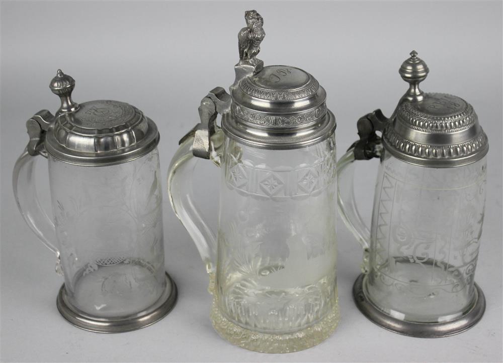 Appraisal: THREE GERMAN HUNTING THEMED PEWTER MOUNTED ENGRAVED GLASS BEER STEINS