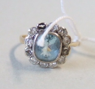 Appraisal: A diamond and pale blue gem set cluster ring mounted