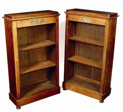 Appraisal: A pair of Empire style mahogany open bookcases with brass