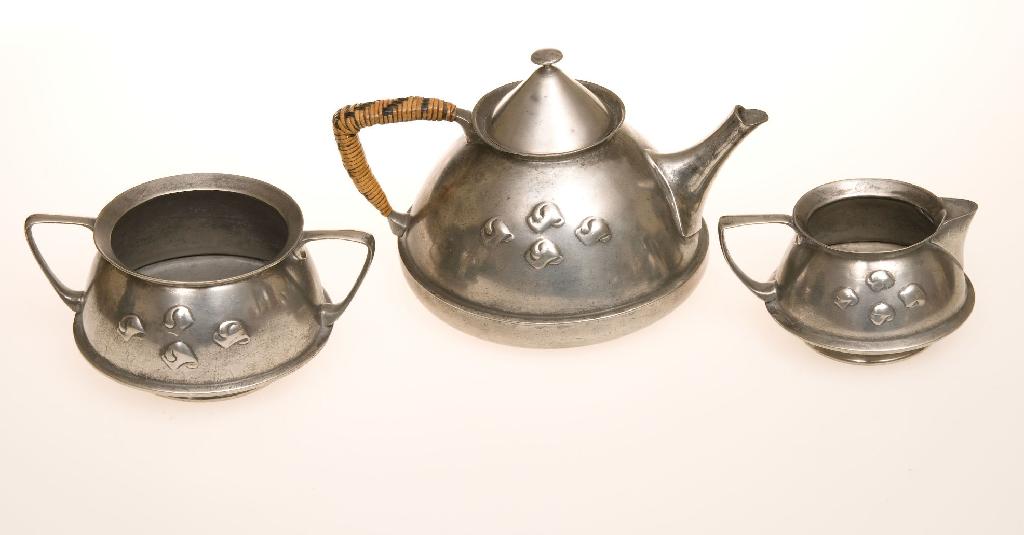 Appraisal: LIBERTY CO ENGLISH PEWTER THREE-PIECE TEA SERVICE DESIGNED BY ARCHIBALD