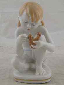 Appraisal: A Soviet Russian ceramic figure of a girl with bird