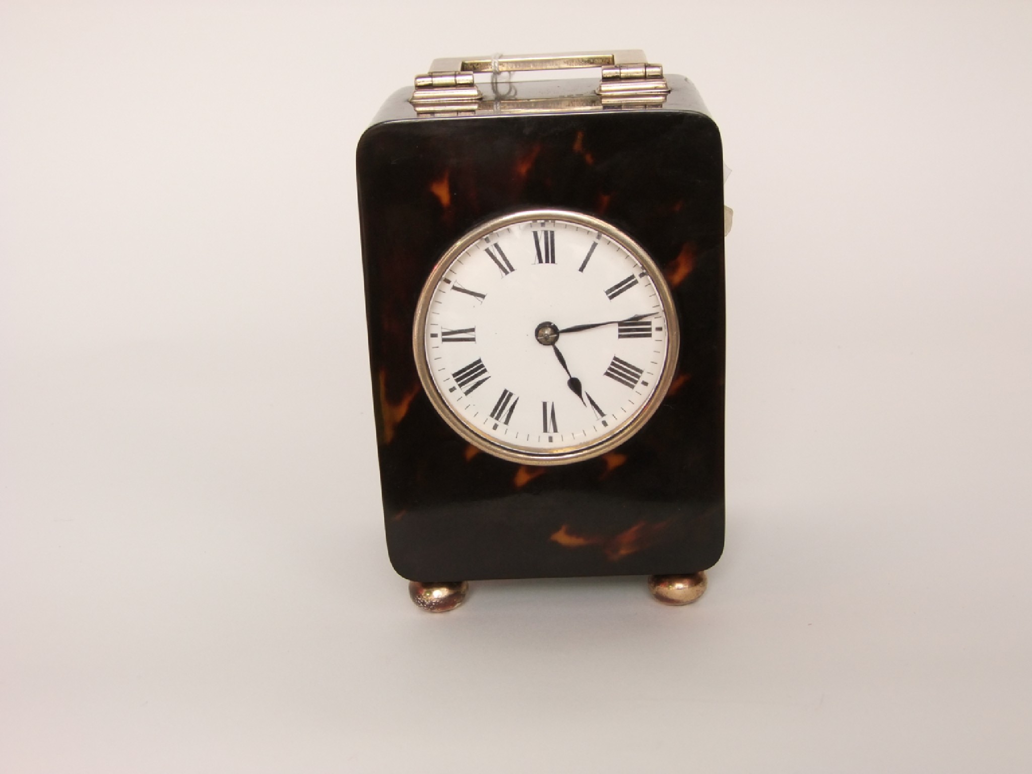 Appraisal: A tortoiseshell and silver mounted mantle clock with enamelled dial