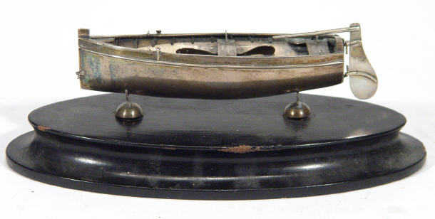 Appraisal: Silver metal model of an open rowing boat with hinged